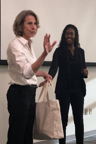 Dr Ellen Shupe giving gift bag to Justice Bolden